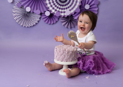 little girl with wooden spoon laughing cake smash chester