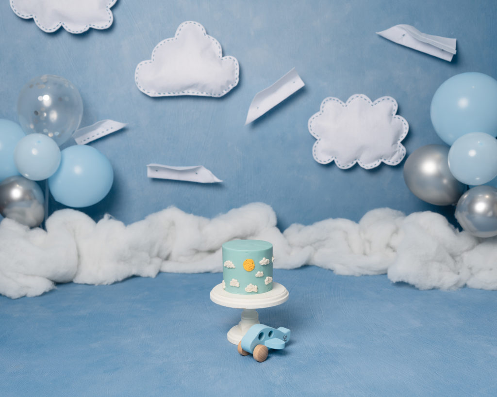 sky blue cake smash with paper planes