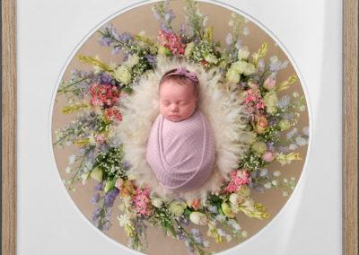 Framed image of a baby girl in a flower wreath. best newborn photographer Taipei, pricing for photoshoot with boho baby international